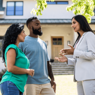 Property management- Couple meeting with real estate agent in front of home
